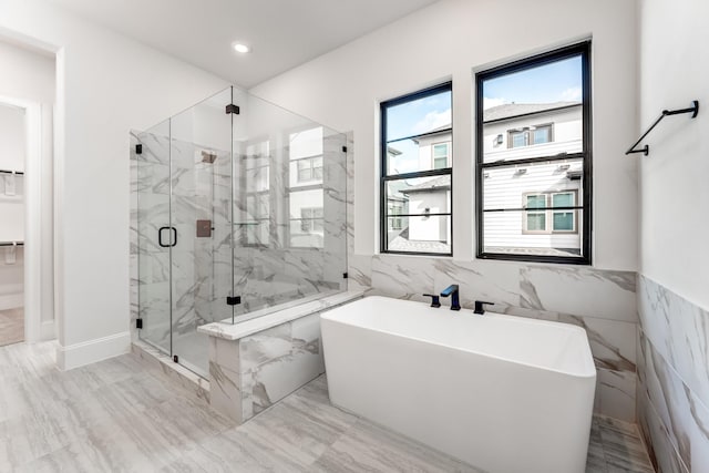 bathroom featuring independent shower and bath