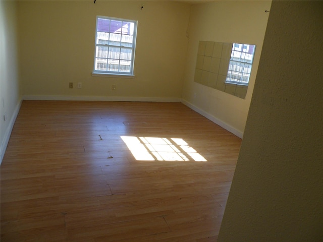 unfurnished room with light hardwood / wood-style floors