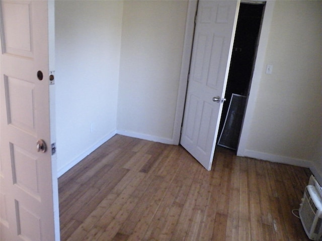 unfurnished bedroom featuring dark wood-type flooring