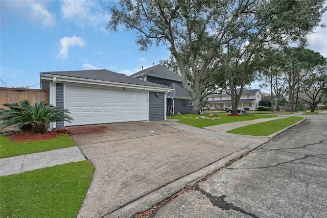 ranch-style home with a garage and a front lawn