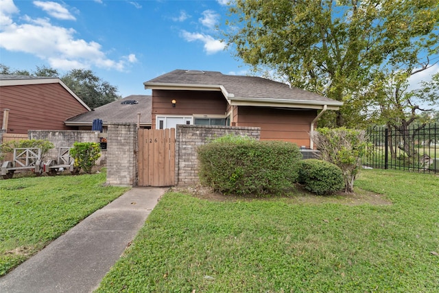 view of side of property with a lawn