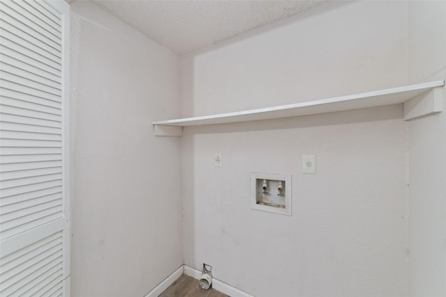 clothes washing area with hardwood / wood-style flooring, hookup for an electric dryer, washer hookup, and a textured ceiling