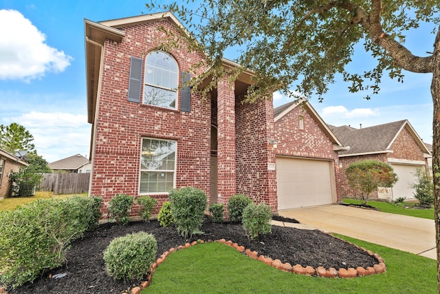 view of front property featuring a garage and a front yard