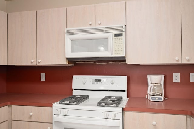 kitchen with white appliances and light brown cabinets