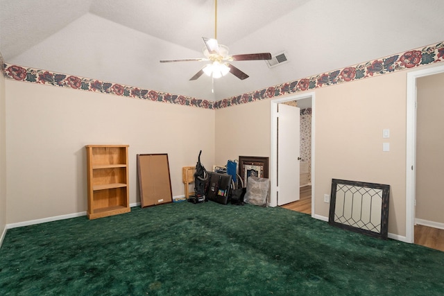 misc room with vaulted ceiling, ceiling fan, and carpet