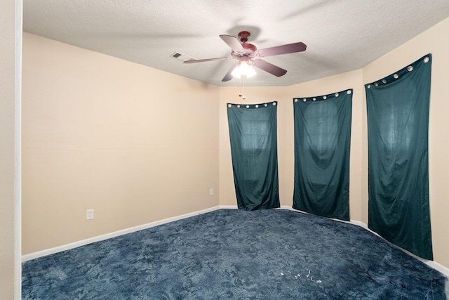 unfurnished bedroom with ceiling fan, carpet floors, and a textured ceiling