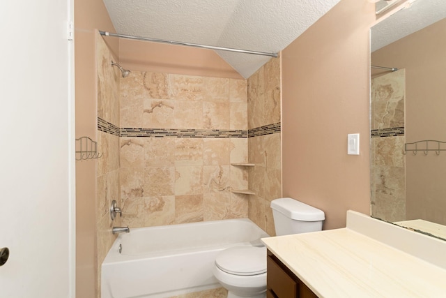 full bathroom featuring tiled shower / bath, vanity, toilet, and a textured ceiling