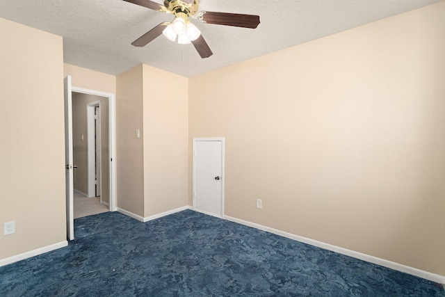 carpeted empty room with a textured ceiling