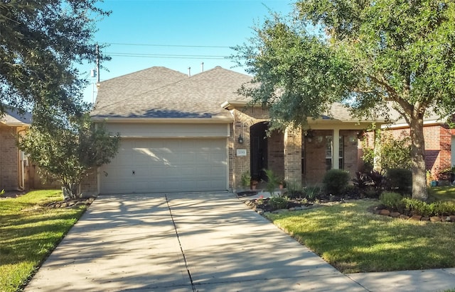 view of front of house with a front yard and a garage