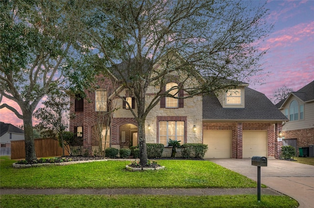 view of front of property with a garage and a lawn