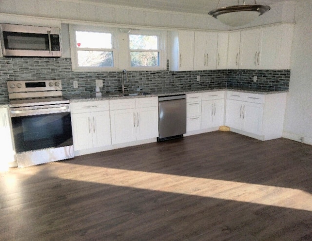 kitchen featuring backsplash, appliances with stainless steel finishes, sink, and white cabinets