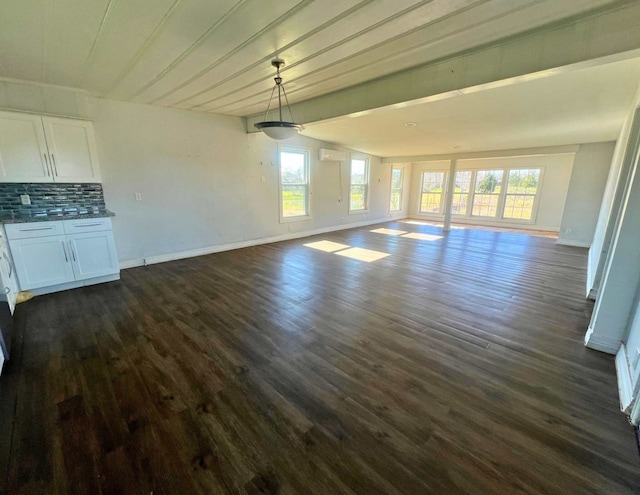 unfurnished living room with a wall mounted air conditioner and dark wood-type flooring