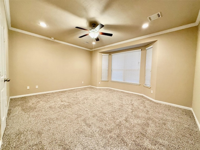carpeted spare room featuring ornamental molding and ceiling fan