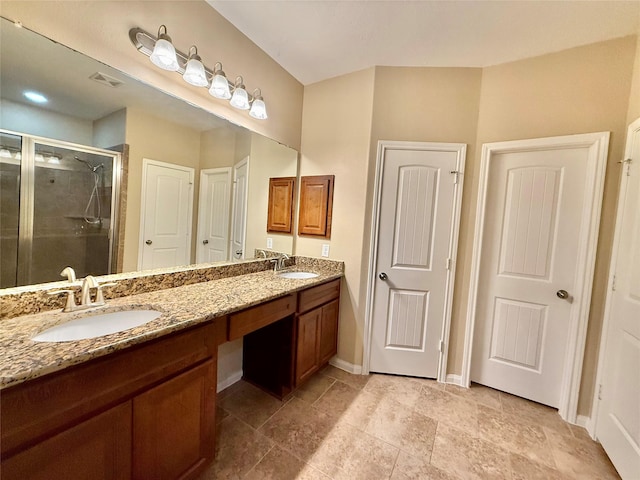 bathroom with vanity and a shower with door