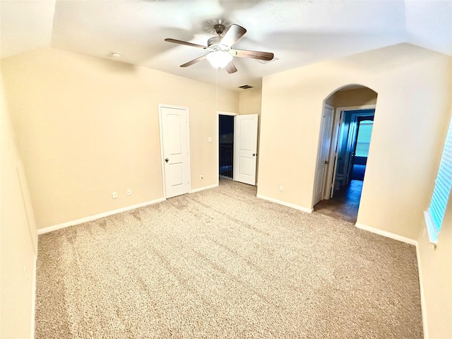 carpeted spare room with ceiling fan and lofted ceiling