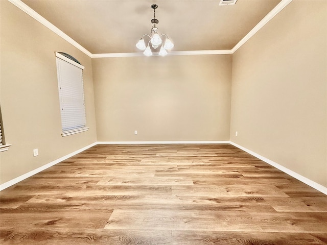 unfurnished room with hardwood / wood-style floors, crown molding, and a chandelier