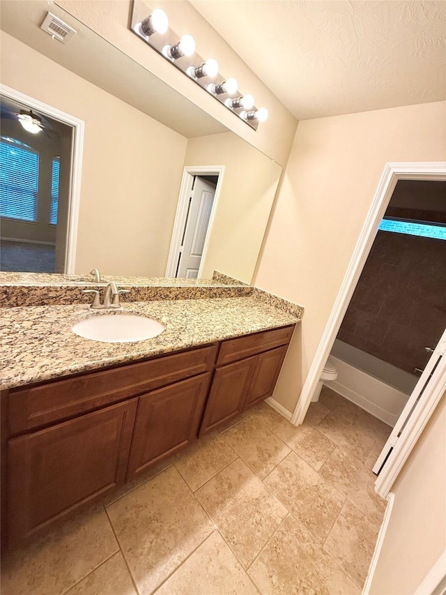 bathroom with vanity and a textured ceiling