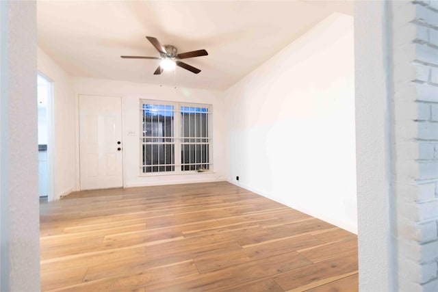 empty room with light hardwood / wood-style floors and ceiling fan