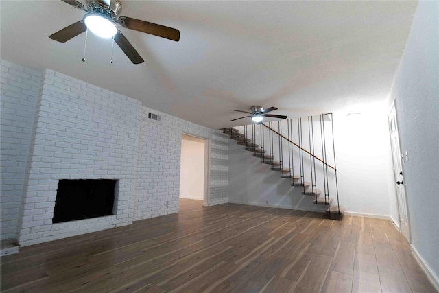 unfurnished living room with dark hardwood / wood-style floors and ceiling fan