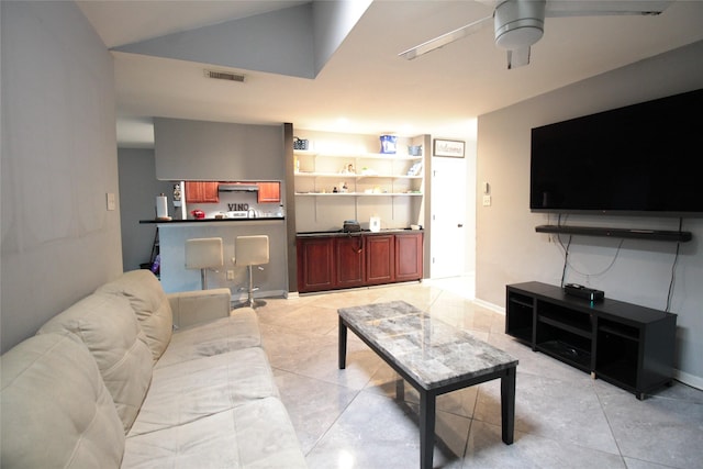 living room featuring vaulted ceiling, ceiling fan, and light tile patterned flooring