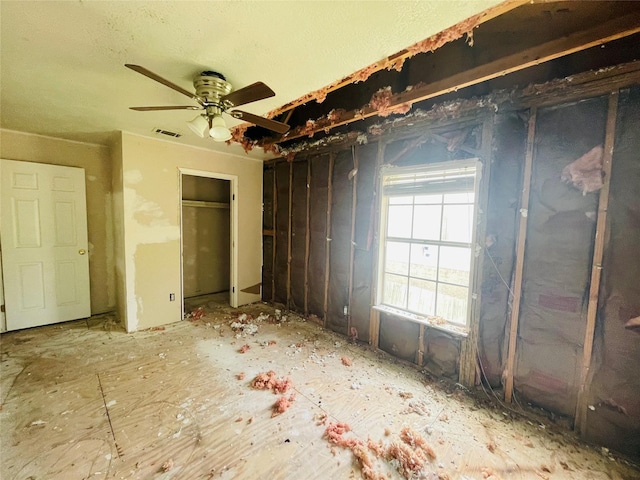 unfurnished bedroom with ceiling fan and two closets