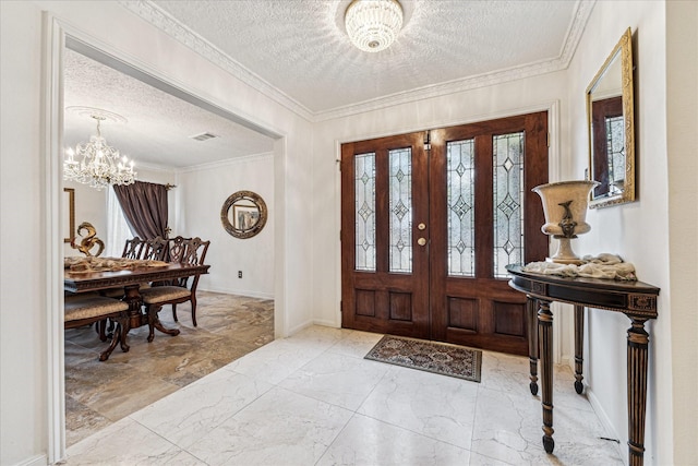 entrance foyer featuring a notable chandelier, ornamental molding, and a textured ceiling