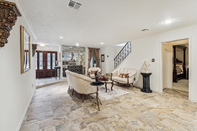 living room with crown molding and a textured ceiling