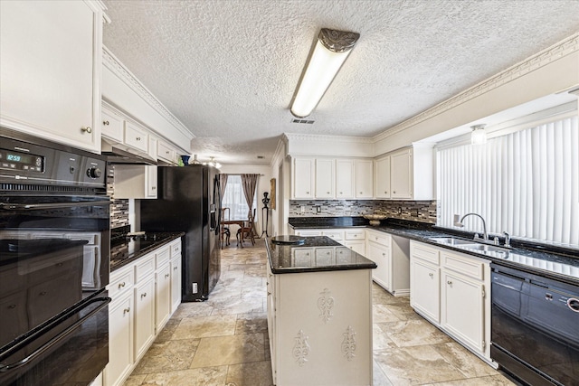 kitchen featuring white cabinetry, sink, backsplash, and a center island