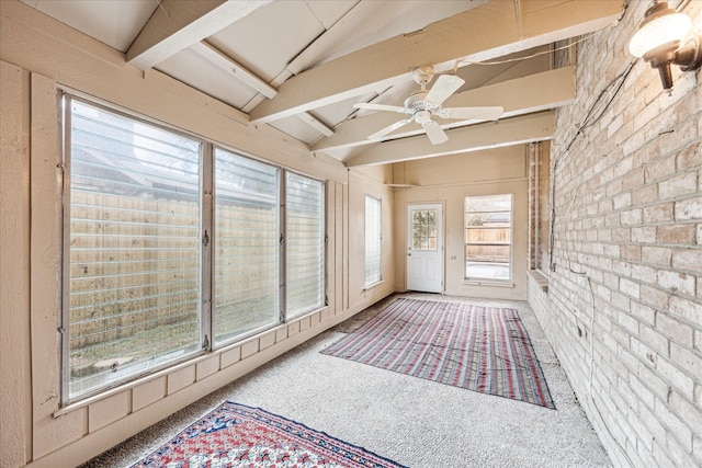 sunroom with ceiling fan and lofted ceiling with beams