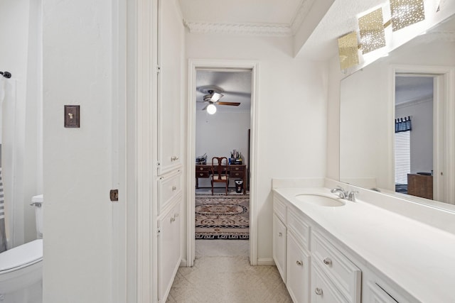 bathroom with vanity, ceiling fan, crown molding, and toilet