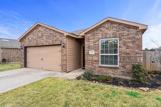 view of front of property with a garage and a front lawn