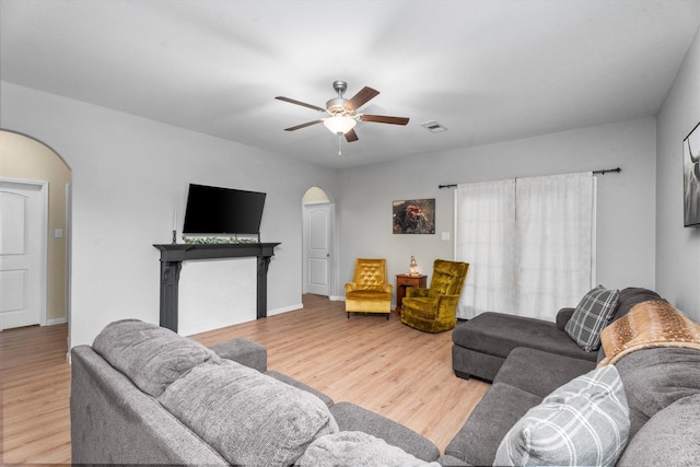 living room with hardwood / wood-style flooring and ceiling fan