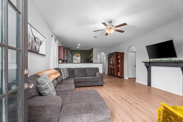 living room featuring ceiling fan and light wood-type flooring