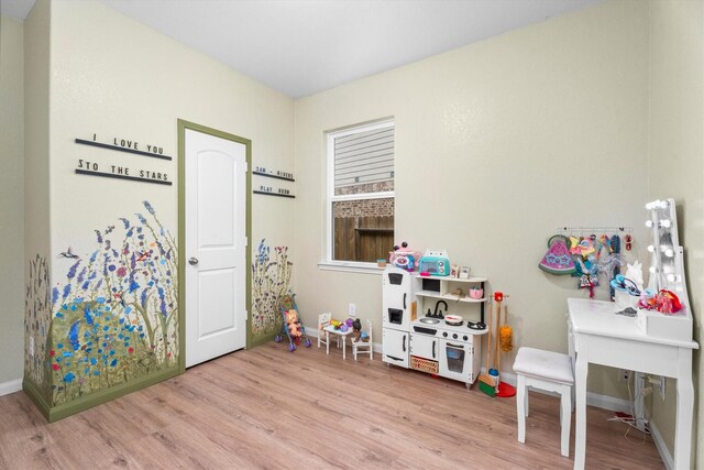 game room with light hardwood / wood-style flooring