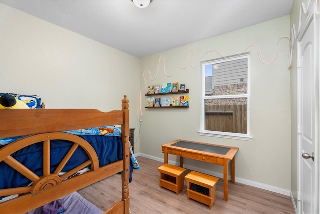 bedroom featuring light wood-type flooring and baseboards