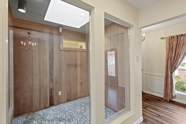 bathroom with hardwood / wood-style floors and a notable chandelier