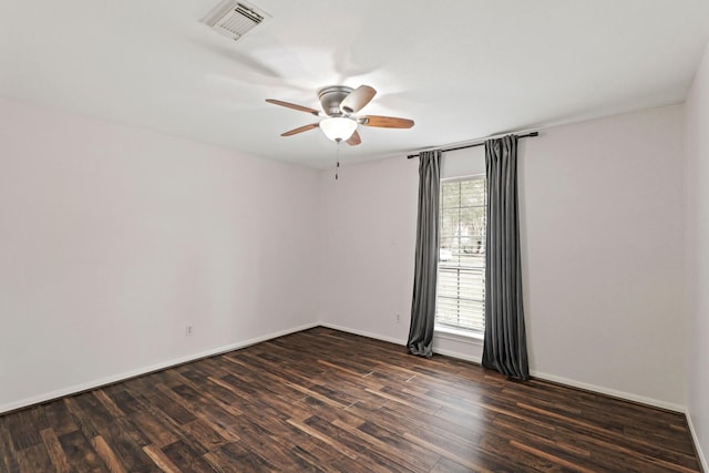 spare room featuring dark hardwood / wood-style flooring and ceiling fan