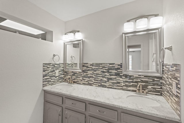 bathroom featuring vanity and backsplash