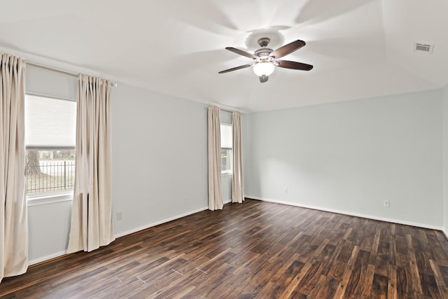 spare room featuring dark wood-type flooring and ceiling fan