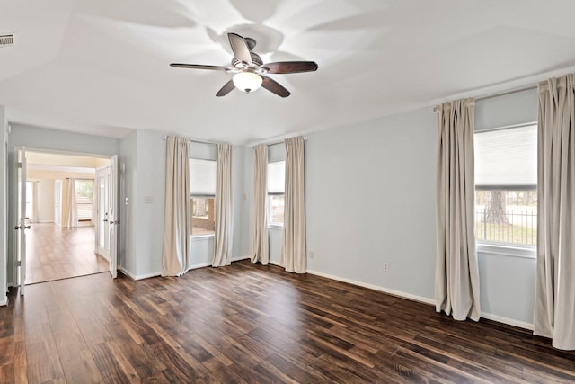 spare room with ceiling fan and dark hardwood / wood-style flooring