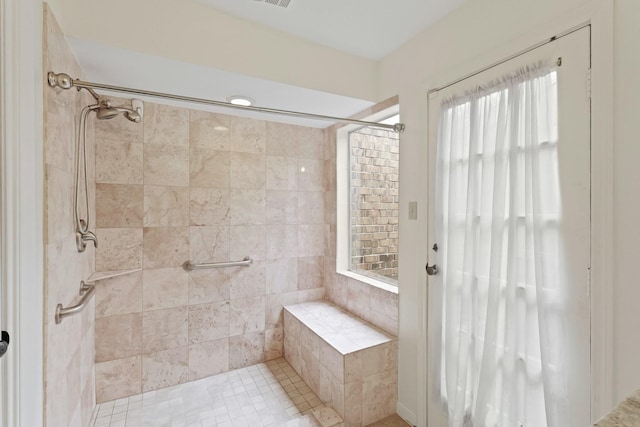 bathroom with a tile shower