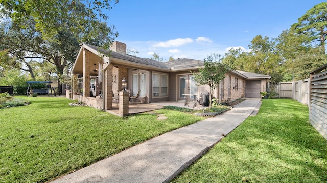 rear view of property with a yard and a patio