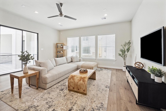 living room with ceiling fan and light wood-type flooring