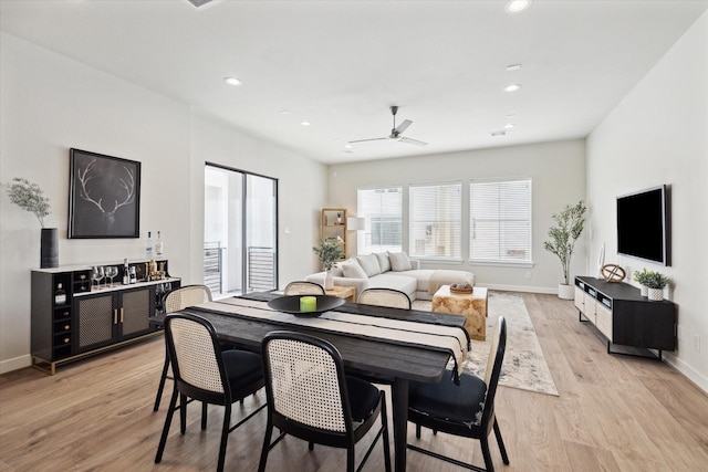 dining room with light wood-type flooring and ceiling fan