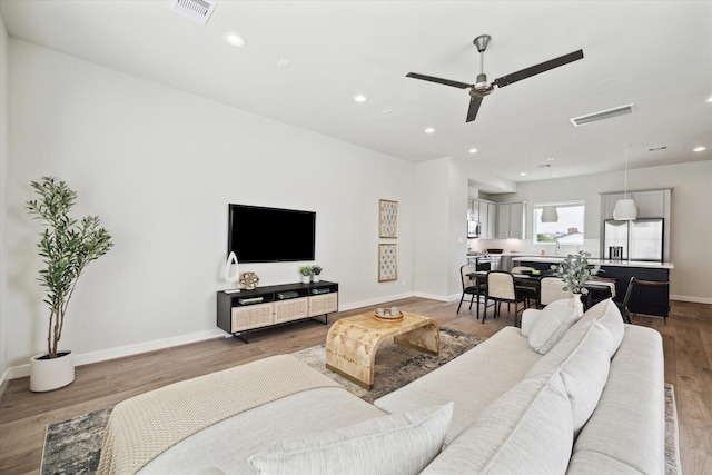 living room with hardwood / wood-style floors and ceiling fan