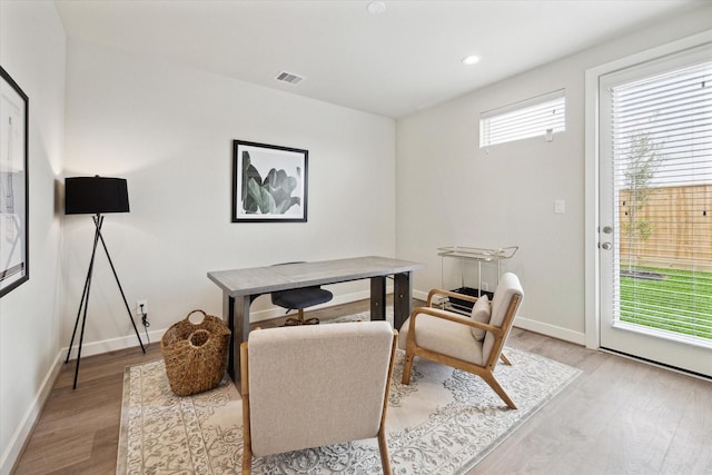 home office with a healthy amount of sunlight and light hardwood / wood-style flooring