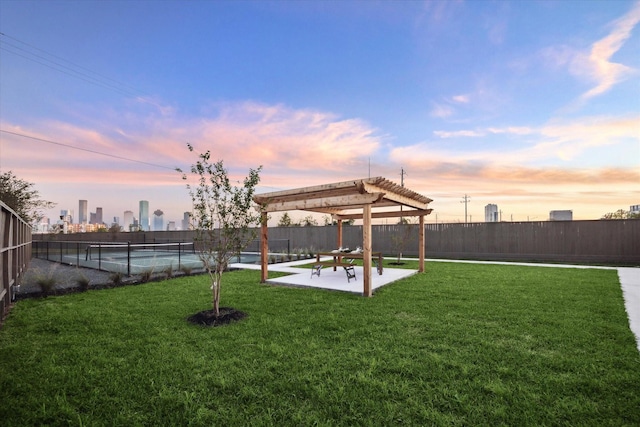 yard at dusk with a patio and a pergola