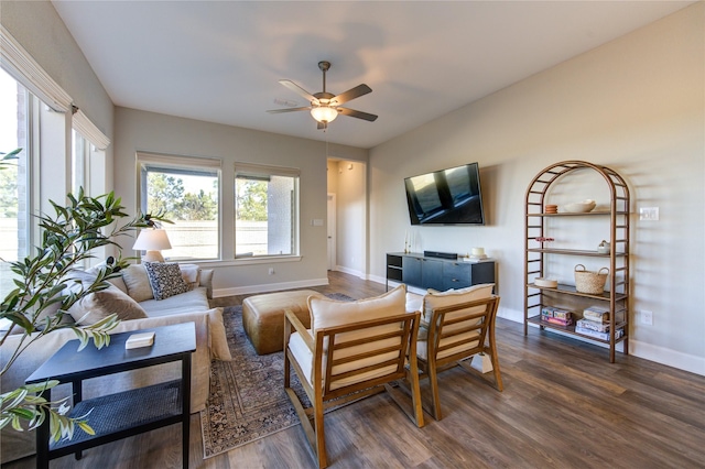 living room with ceiling fan and dark hardwood / wood-style flooring