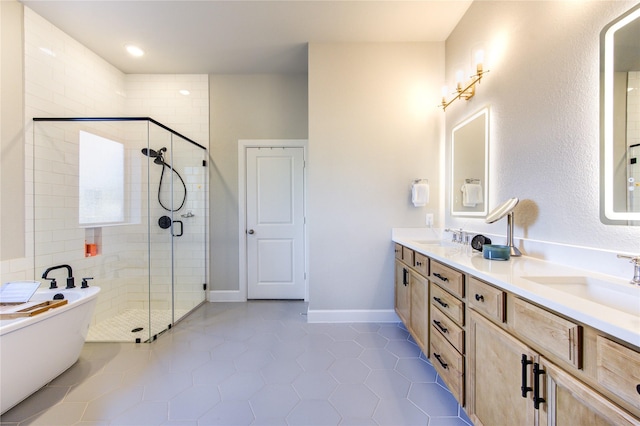 bathroom featuring independent shower and bath, vanity, and tile patterned floors