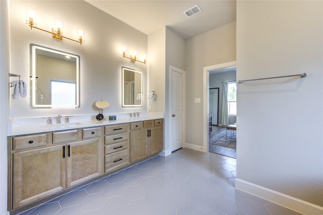 bathroom with tile patterned flooring and vanity